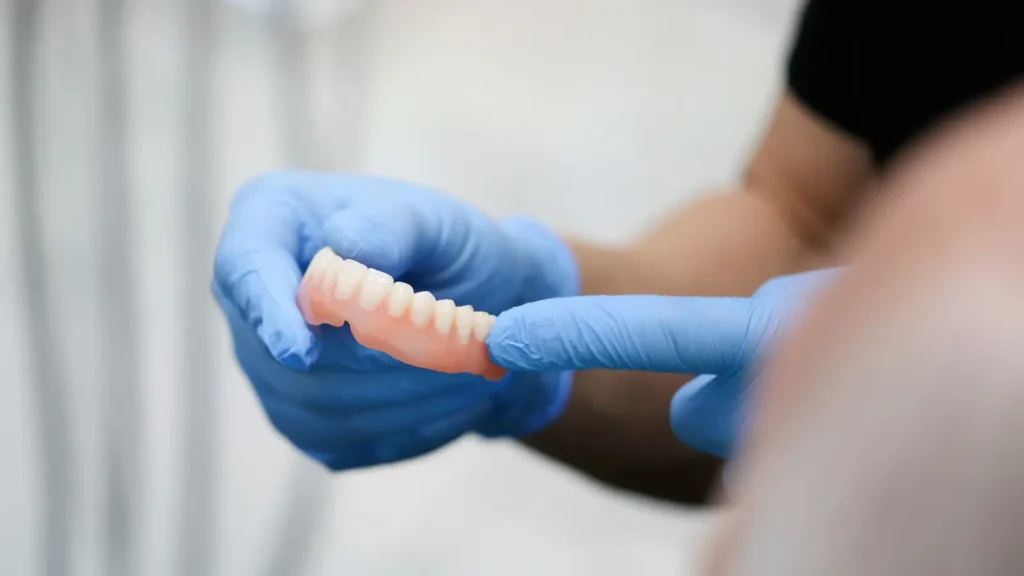 dentist showing patient dentures